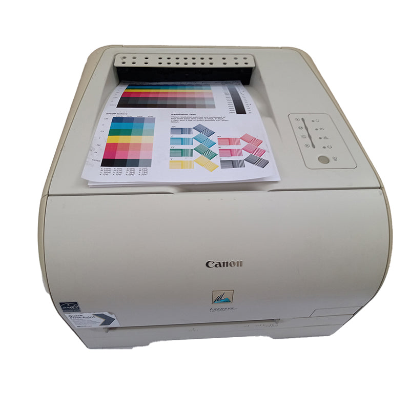 Canon i-SENSYS LBP-5050 color laser printer showing printed test page with vibrant colors.