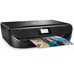HP Envy 5030 printer in action, multifunction inkjet with auto-duplex and Wi-Fi, printing high-quality color photograph.