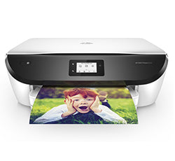 HP Envy Photo 6232 All-in-One printer printing a photo of a child, showcasing wireless printing and high-resolution capabilities.