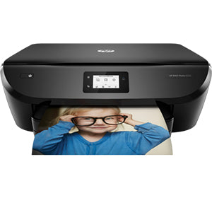 HP Envy Photo 6255 printer displaying printed photo with child wearing glasses.